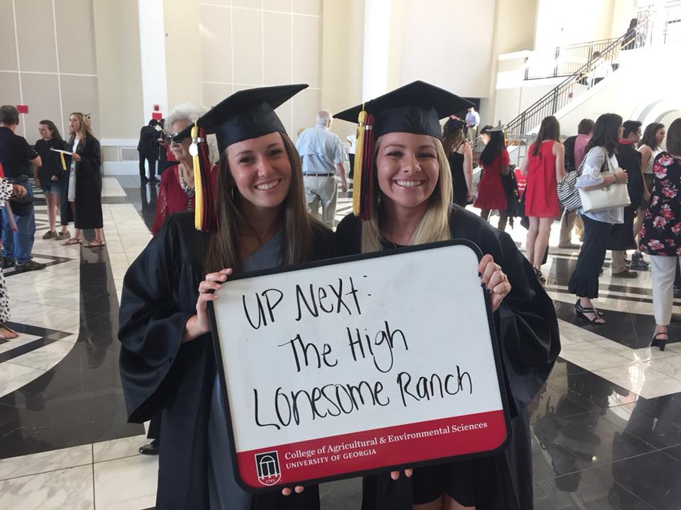 CAES grads hold up sign that says: "Up next: The High Lonesome Ranch"